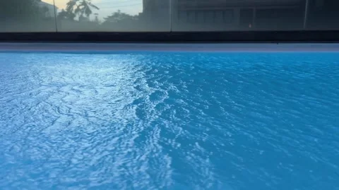 A shot of a clear pool water rippling in a holiday house Blue pool water Stock Footage 306271755
