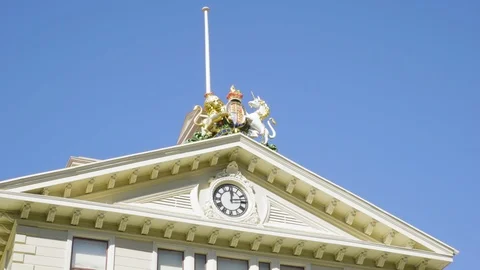 A shot of the clock and statues sitting on top of the Old Government Stock Footage 115387722