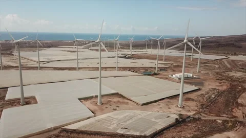 Shot in close orbit over a wind farm in an almost desert environment. Stock Footage 246053581