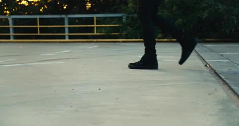 Shot close to Pearson with black boots and black pants spreading orange cones on Stock Footage 249235634