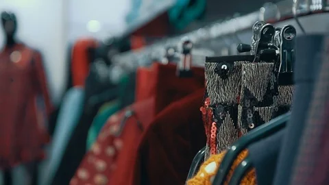 Shot close-up women's clothes hanging on hangers in the store. Stock Footage 73549319