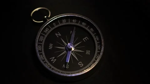 A shot of a compass on a black background Stock Footage 169133177