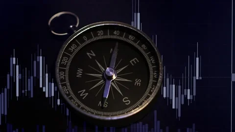 A shot of a compass with trading graph Video stock 169133182