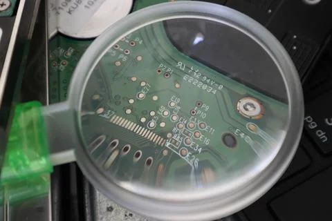 Shot of a computer processor through a magnifying glass Foto stock