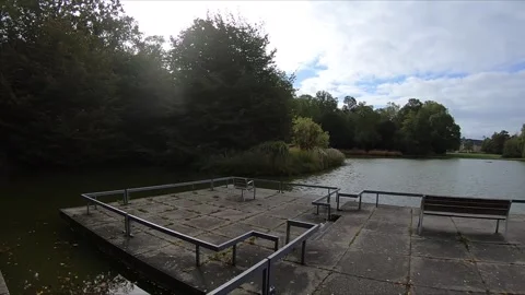 Shot of Concrete Lake Observation Deck Overlooking Calm Water on a Cloudy Day Stock Footage 333324063