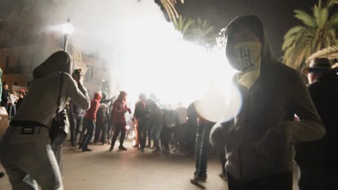 Shot of Correfoc fireworks expoding in the middle of a big crowd Stock Footage 100386676