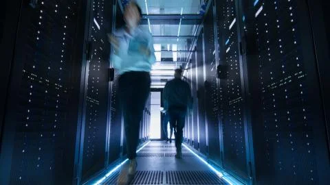 Shot of Corridor in Large Data Center Full of Walking and Working People. Pro Stock Photos