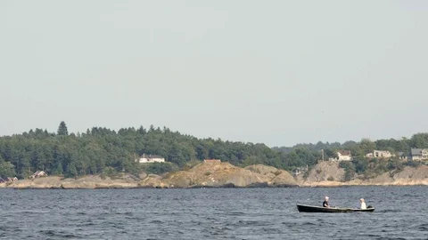Shot of couple rowing along Odderøya, Kristiansand - Norway Stock Footage 71345036