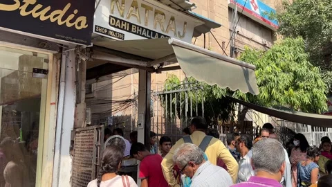 A shot of Crowd at Natraj Dahi Bhalla Street Food Stall Chandni Chowk Delhi Stock-Footage 332105015