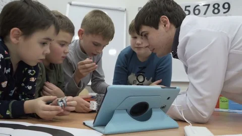 Shot of cute kids building motorized robot at elementary school Stock Footage 82446341