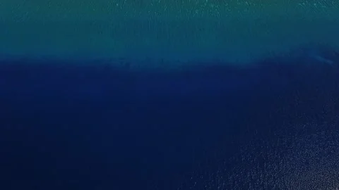 Shot from deep blue ocean to paradise lagoon in Maldives island with bungalow Stock Footage 120682148
