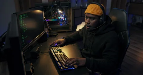 Shot of delighted guy playing video games on computer in led-lit room man won Stock Footage 178586434