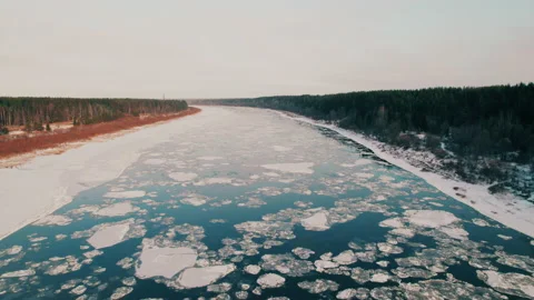 Shot on a drone. Chunks of ice float down the river downstream. Winter icing. Stock Footage 221467586