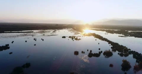 Shot of the drone going towards the sun over the delta at sunrise Stock Footage 257956171