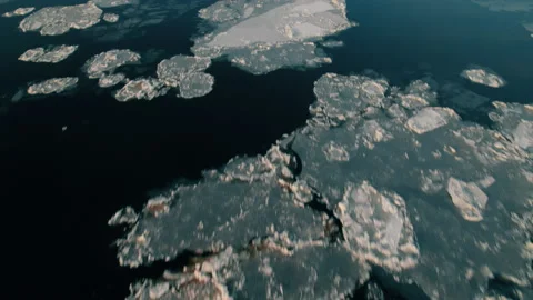 Shot on a drone. Large chunks of ice float down the river before freezing. Stock Footage 221467820