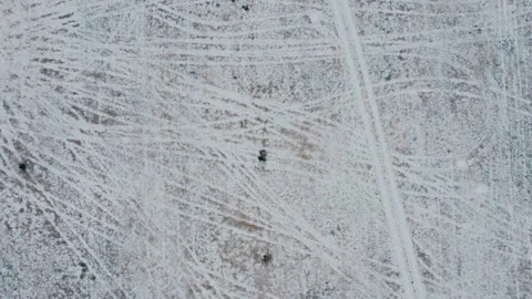 Shot on a drone.A man in a field digs metal out of the ground with a shovel. Stock Footage 221165037