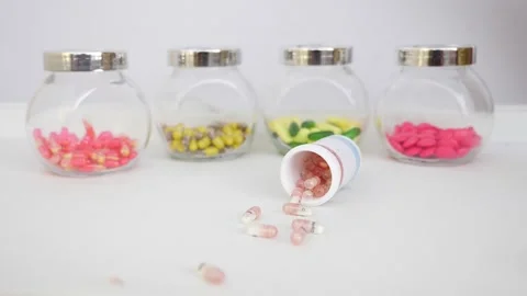 Shot of dropping bottle filled with capsule on a table Vídeo Stock 147699818