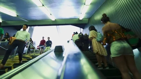 Shot from escalator of people going up and some down through stairs at metro Stock Footage 78078156