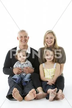 Shot Of Family Group Sitting In Studio Stock Photos