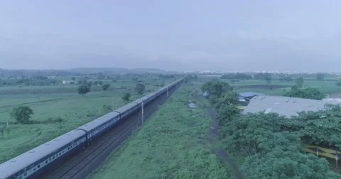 A shot of the fast moving train passing through a green farm Stock Footage 134860970