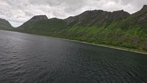 Shot from ferry deck sailing past green mountain ridge in Gryllefjord Norway Vídeos de archivo 342755815