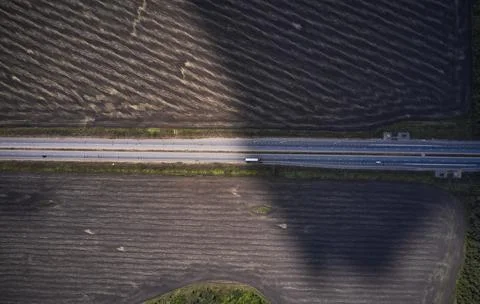 Shot of the field from drone. Road between fields. Background or texture Stock Photos