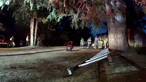 Shot of firefighters at the scene of a structure fire Stock Footage 71089008