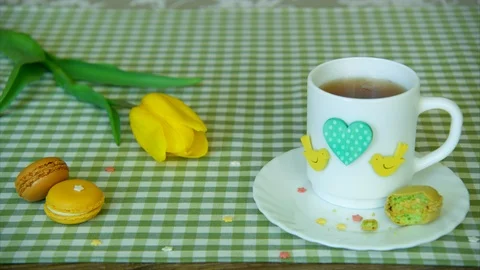 Shot with free space for lettering, using yellow tulip, a white cup of tea Stock Footage 86127850
