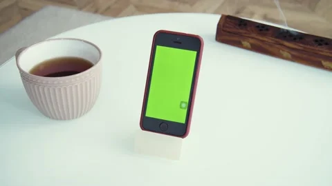 Shot of green screen template smartphone at home, gadget on the table. Couple of Stock Footage 153056991