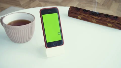 Shot of green screen template smartphone at home, gadget on the table. Couple of Stock Footage 153057478