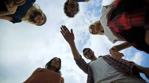 Shot of a group of young friends piling their hands together Stock Footage 68798870