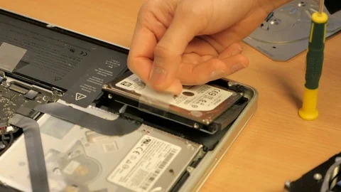 Shot of a guy opening the harddrive of his mac Stock Footage 71353059