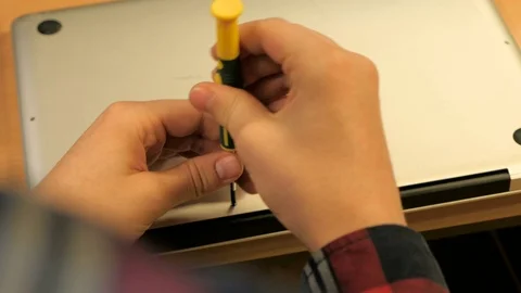 Shot of an guy opening a mac with his screwdriver Stock Footage 71342464