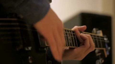 Shot of a guy playing guitar for recording Stock Footage 71332731