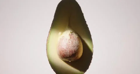 Shot of half raw fresh avocado fruit rotating. Stock Footage 330753001