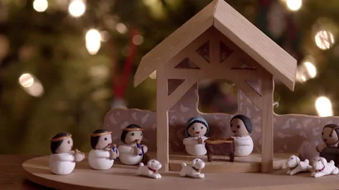 Shot of hand made nativity set with christmas lights in background Stock Footage 166636979