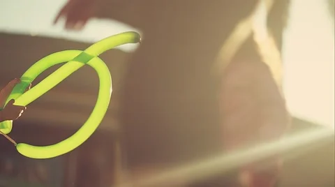 Shot of hands of kid playing wih balloon at park, taken against light Stock Footage 49615561