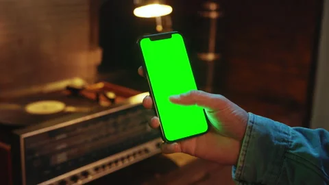 Shot of hands man using scrolling mobile phone with a vertical green screen Stock Footage 238751685