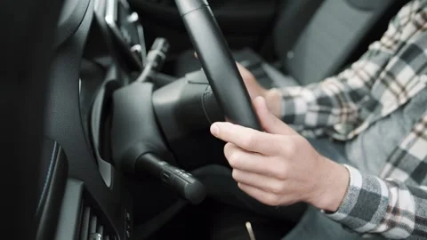 Shot of hands young man driving a new luxury electric car in a car dealership Video stock 241417783