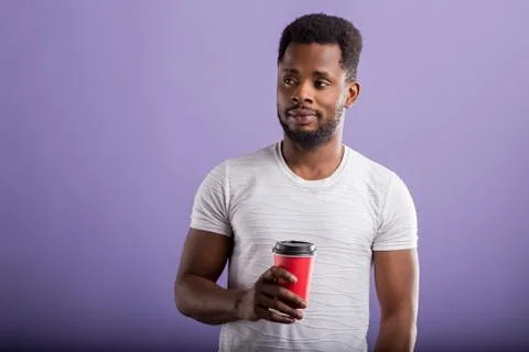 Shot of handsome black man holds takeaway coffee Stock Photos