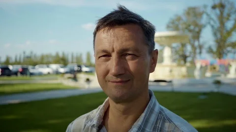Shot of handsome man look at camera smile feel happy summer elderly face outdoor Stock Footage 116997245