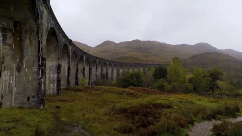 Shot of the Harry Potter train in glenfinnan viaduct in Scotland Stock Footage