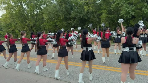 A shot of a high school drill team performing in a homecoming parade Stock-Footage 346516340
