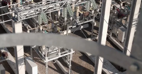 Up shot of high voltage power lines and substation from above Vídeo Stock 329100461