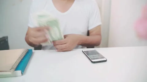Shot of human hands counting american dollars. a man counts money on a calc.. Stock Footage 266471196