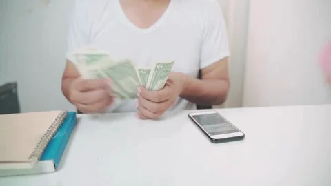 Shot of human hands counting american dollars. a man counts money on a Stock-Footage 336260814