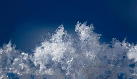 Shot of ice crystals. Winter pattern with white snowflakes on the background of Photos