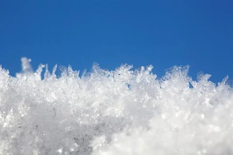 Shot of ice crystals. Winter pattern with white snowflakes on the background of Stock Photos