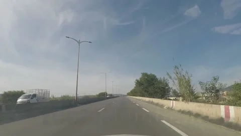 A shot from inside the car on a highway in a mountain area with few trees Video stock 149000806