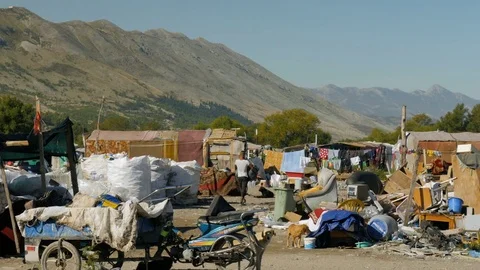 Shot inside a Romanian camp in Shkodër, Albania, man walking Stock Footage 84679780